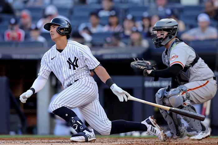 Apr 1, 2023; Bronx, New York, USA; New York Yankees shortstop Anthony Volpe (11) follows through on a single against the San Francisco Giants during the second inning at Yankee Stadium. The hit was hit first major league hit.